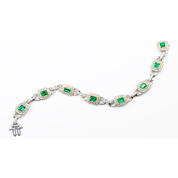 8-3.64 Emerald Cut Emerald Bracelet set with 472-3.66 White Melee Round Diamonds. Set in 18KWG & 18KYG with 25.57 grms.
